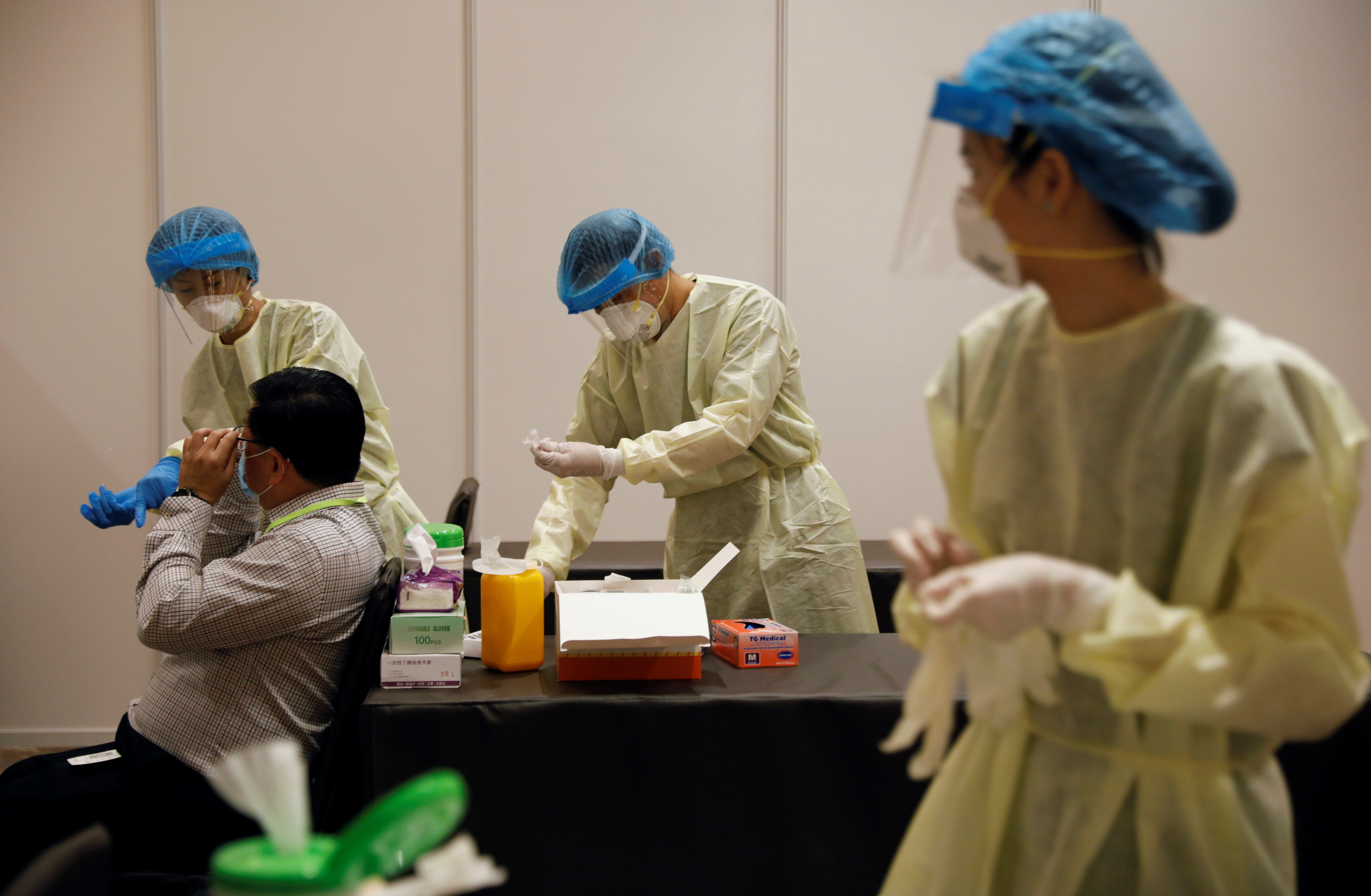 An attendee receives a nose swab as part of a coronavirus disease (COVID-19) antigen rapid test before a conference held by the Institute of Policy Studies at Marina Bay Sands Convention Centre in Singapore January 25, 2021.