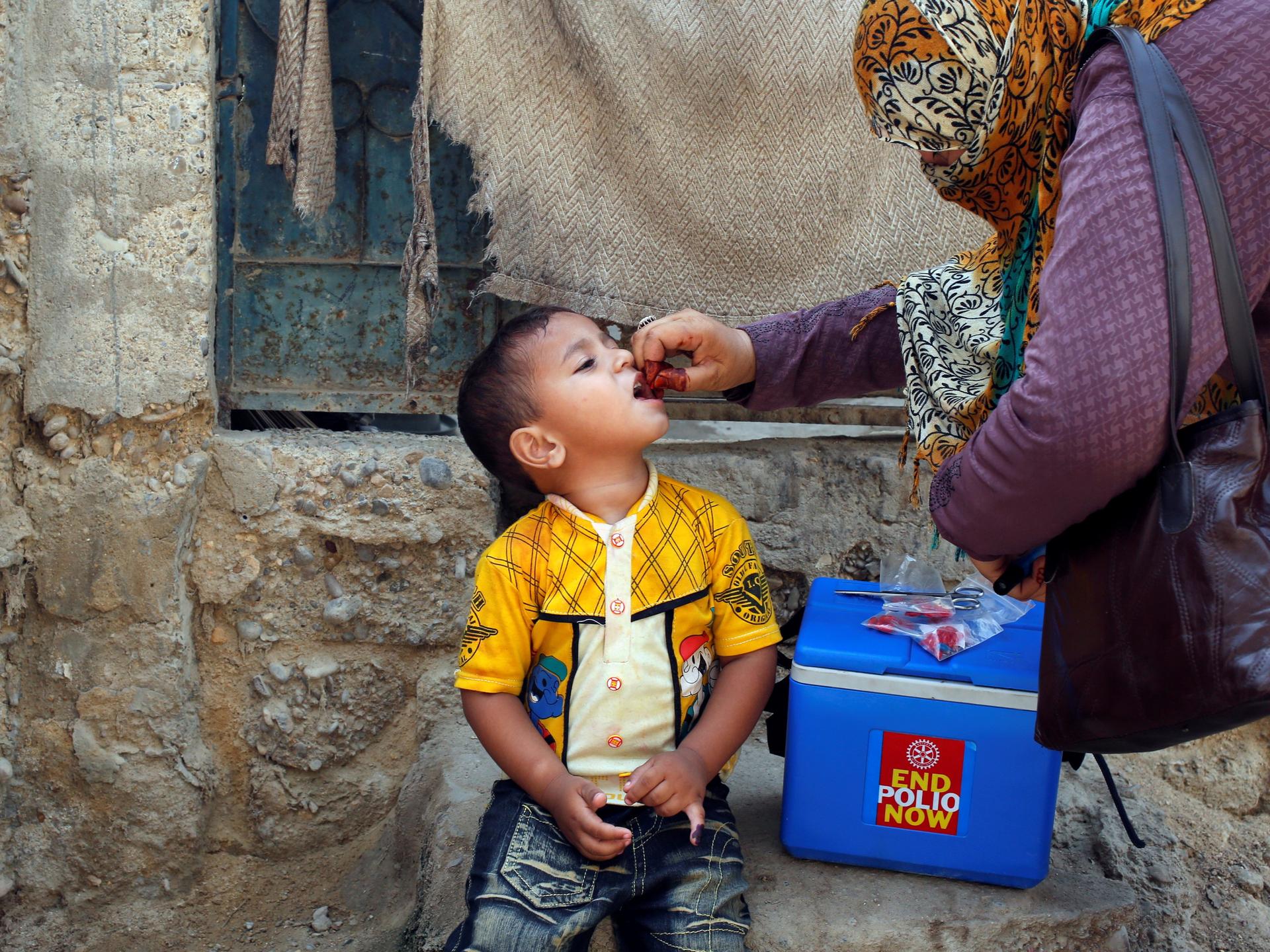 A boy receives polio vaccine drops, during a polio vaccination campaign, in Karachi, Pakistan, on April 9, 2018. 