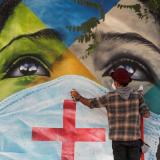 Brazilian graffiti artist Eduardo Kobra puts the final touches to his mural Coexistencia—Memorial da Fe por todas as vitimas do Covid-19, translated as Coexistence—Memorial of Faith for All Victims of Covid-19, which shows children of different religions wearing protective face masks, in Sao Paulo, Brazil, on May 5, 2021.