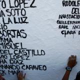 The names of people who died from the coronavirus disease are painted on a wall by members of the non-profit organization Ataraxia, in Ciudad Juarez, Mexico, on July 31, 2021.