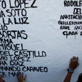 The names of people who died from the coronavirus disease are painted on a wall by members of the non-profit organization Ataraxia, in Ciudad Juarez, Mexico, on July 31, 2021.