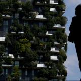 A person views the Bosco Verticale, or Verticle Forest, in Milan, Italy.