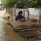 After a period of intense flooding, a man uses a floating public toilet on the Ciliwung river bank in Jakarta, Indonesia, on December 28, 2006. 