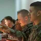 U.S. peacekeepers at camp Bondsteel in southern Kosovo line up to pick a rich selection of dishes, including roast turkey with giblet gravy, during their celebration of Thanksgivings day on Thursday November 22, 2001.