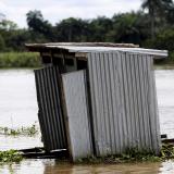 A toilet floats on the river Nun near Yenagoa, Bayelsa state in Nigeria's delta region October 8, 2015.