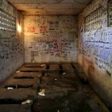 Posters, including those advertising treatments for sexually transmitted diseases, are stuck to the walls of a public toilet in a residential area for migrant workers in Shigezhuang village, Beijing, China, October 13, 2015.