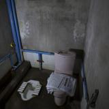 Newspapers are seen on a toilet seat next to a traditional squat toilet in a private home in Mandalay, Myanmar, October 5, 2015.