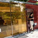 Visitors try out the transparent public toilets that become opaque when occupied, designed by Japanese architect Shigeru Ban, at Yoyogi Fukamachi Mini Park in Tokyo, Japan August 26, 2020.