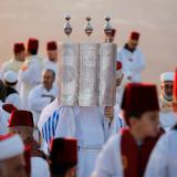 A member of the Samaritan sect holds a Torah scroll during a traditional pilgrimage marking the holiday of Sukkot, or Feast of Tabernacles, atop Mount Gerizim near Nablus in the occupied West Bank, Israel, on October 20, 2021.