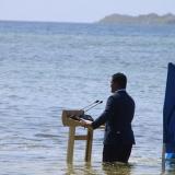 Tuvalu's Minister for Justice, Communication & Foreign Affairs Simon Kofe gives a COP26 speech while standing knee-deep in the ocean in Funafuti, Tuvalu, on November 5.
