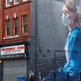A mural of a health-care worker climbs three stories high along the side of a building in Manchester, United Kingdom, on October 19, 2020.