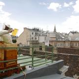 Felix Munk, head of the beekeeper organization Stadtimker, holds a honeycomb next to bee hives at the rooftop of the Austrian chancellery, in Vienna, Austria