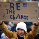 In many cities around the world, climate activists marched to send a message to decision-makers in Glasgow. At a London protest, a child holds a banner on November 6, 2021.