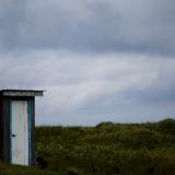 A toilet stands in a field on private property in the town of Yuzhno-Kurilsk on Kunashir Island which is part of the Kuril Islands group in Russia, September 16, 2015