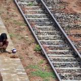 A girl plays with clay next to a railway track in Agartala, India on May 28, 2015.