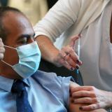 A medical worker vaccinates a man against the coronavirus disease as Israel kicks off a coronavirus vaccination drive, at Tel Aviv Sourasky Medical Center in Tel Aviv, Israel on December 20, 2020.