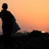 A boy stands in a garbage dump where his family collects food to eat, near the Red Sea port city of Hodeidah, Yemen on January 13, 2018.