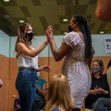 Teens  high five after Croix received her first COVID vaccine at the Ochsner Center for Primary Care and Wellness, in New Orleans, Louisiana, May 13, 2021.