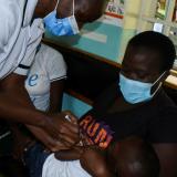 Pamela Omboko, a nurse at the Yala Sub-County Hospital Mother and Child Healthcare clinic in Kenya prepares to vaccinate a child against malaria