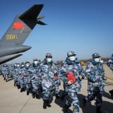 Medical personnel in blue camouflage uniforms arrive with medical supplies in transport aircraft of the Chinese People's Liberation Army (PLA) Air Force.