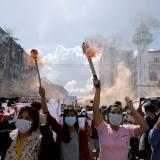  a group of women hold torches to protest the military coup in Yangon, Myanmar