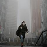 A man walks in the Sanlitun shopping district on a polluted day, in Beijing, China,