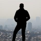 A man stands at a lookout point over Tehran following an increase in air pollution in Tehran, Iran,