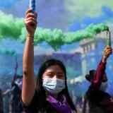 Women hold up smoke bombs during a protest to mark the International Day for the Elimination of Violence Against Women, in Guatemala City, Guatemala November 25, 2021