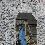 A cleaner in personal protection equipment clears garbage at a venue office decorated for the Lunar New Year at Yanqing National Alpine Ski Centre ahead of the Beijing 2022 Winter Olympics in Yanqing district of Beijing, China, January 30, 2022. 