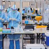 Medical workers wearing personal protective equipment (PPE), designed to prevent the spread of the coronavirus disease (COVID-19), work at a COVID-19 testing site at Beijing Capital International Airport ahead of the Beijing 2022 Winter Olympics in Beijing, China January 31, 2022.