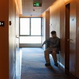 man sits in hallway