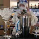 A bartender in personal protective equipment (PPE) prepares a cocktail in a hotel for journalists and officials of the Beijing 2022 Winter Olympics, in Zhangjiakou, China, February 3, 2022.