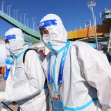 Staff members in personal protective equipment (PPE) during training