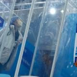 Dr. Ding Hongtao, part of the medical staff, blows a kiss to his girlfriend through screens of glass that separate them because of the "closed loop," a coronavirus disease (COVID-19) prevention measure