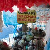 a placard that reads "Brantas river polluted with microplastics," is seen among plastic bags displayed at the plastic museum constructed by Indonesia's environmental activist group Ecological Observation and Wetlands Conservation