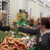 A woman buys vegetables from a vendor on the first day of Ramadan, the Muslim holy fasting month, in a market downtown in Tunis,Tunisia, on June 18, 2015. 