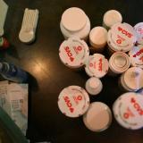 Julie Fallon, who describes her long COVID symptoms as “extreme cognitive challenges,” has her medications gathered on her kitchen counter at her home in Colrain, Massachusetts, on June 15, 2022.