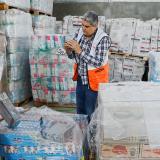 Two men are seen over containers of aid 