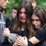 People react as they pay tribute following a school mass shooting after a boy opened fire on others, killing fellow students and staff in Belgrade, Serbia, May 4, 2023. 