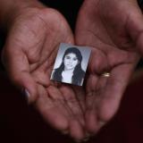 A family member holds a photograph of Rosivel Elisabeth Grande in Quezaltepeque, Honduras, on July 2, 2013. Grande was killed by an unidentified man who shot her five times when she was going to work 