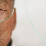 Hu Hushen, a 78 year old former miner, breathes using a nasal cannula for oxygen supply outside his room at Yangjia Hospital in Wuyi County, Zhejiang Province, China October 19, 2015.