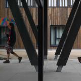 Alzheimer’s patient Laetitia, thirty-nine, is reflected in a mirror as she walks with an umbrella at the Village Landais Alzheimer site in Dax, France, on September 24, 2020. 