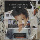 A poster of an infant reading Estoy Buscando A Mi Familia, or "I’m looking for my family"