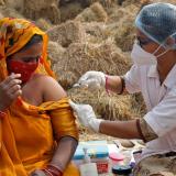A woman receives a dose of COVISHIELD vaccine against COVID-19, that's manufactured by Serum Institute of India.