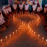 School girls light candles in the shape of a ribbon during a HIV/AIDS awareness campaign ahead of World Aids Day, in Ahmedabad, India November 30, 2016.