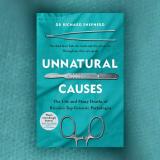 Photo of a turquoise book cover reading "unnatural causes" in white font 
