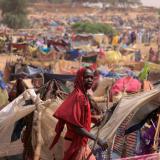 A Sudanese girl moves past makeshift shelters near the border between Sudan and Chad, while taking refuge in Borota, Chad, May 13, 2023.