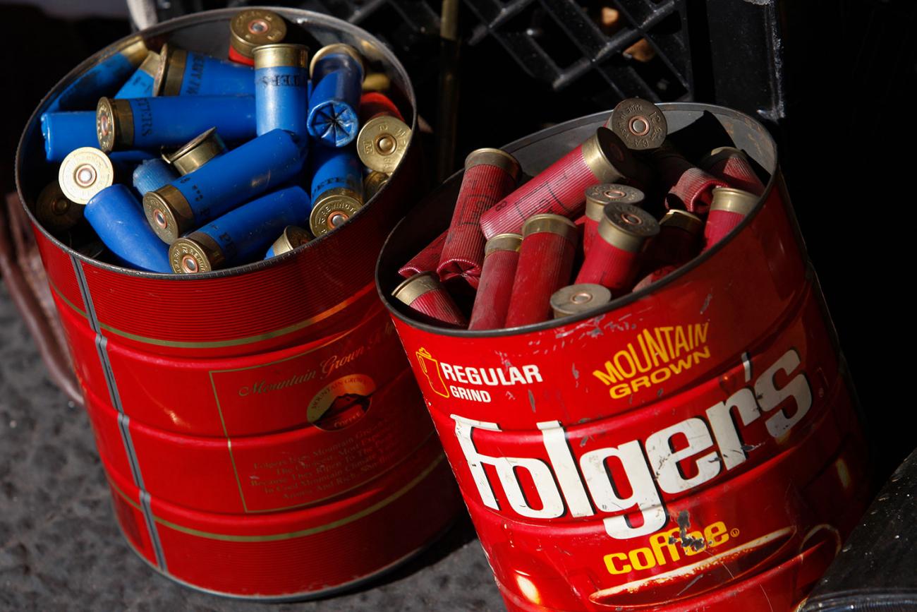 Old coffee cans of shotgun shells dropped off to the Los Angeles County Sheriff's Department at the “Gifts for Guns” buyback in Compton, California on January 21, 2013. Picture shows two bright red, rusted out coffee tins filled to the brim with shotgun shells, red shells in the first tin, blue in the second. REUTERS/David McNew