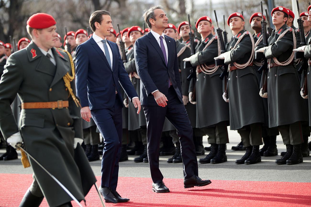 The photo shows the two leaders walking alongside a highly polished military guard. 