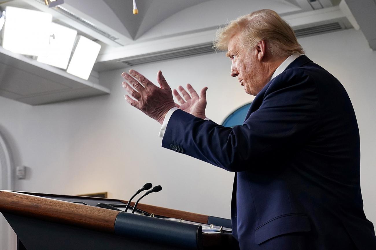 Image shows the president from the side speaking at a podium. 